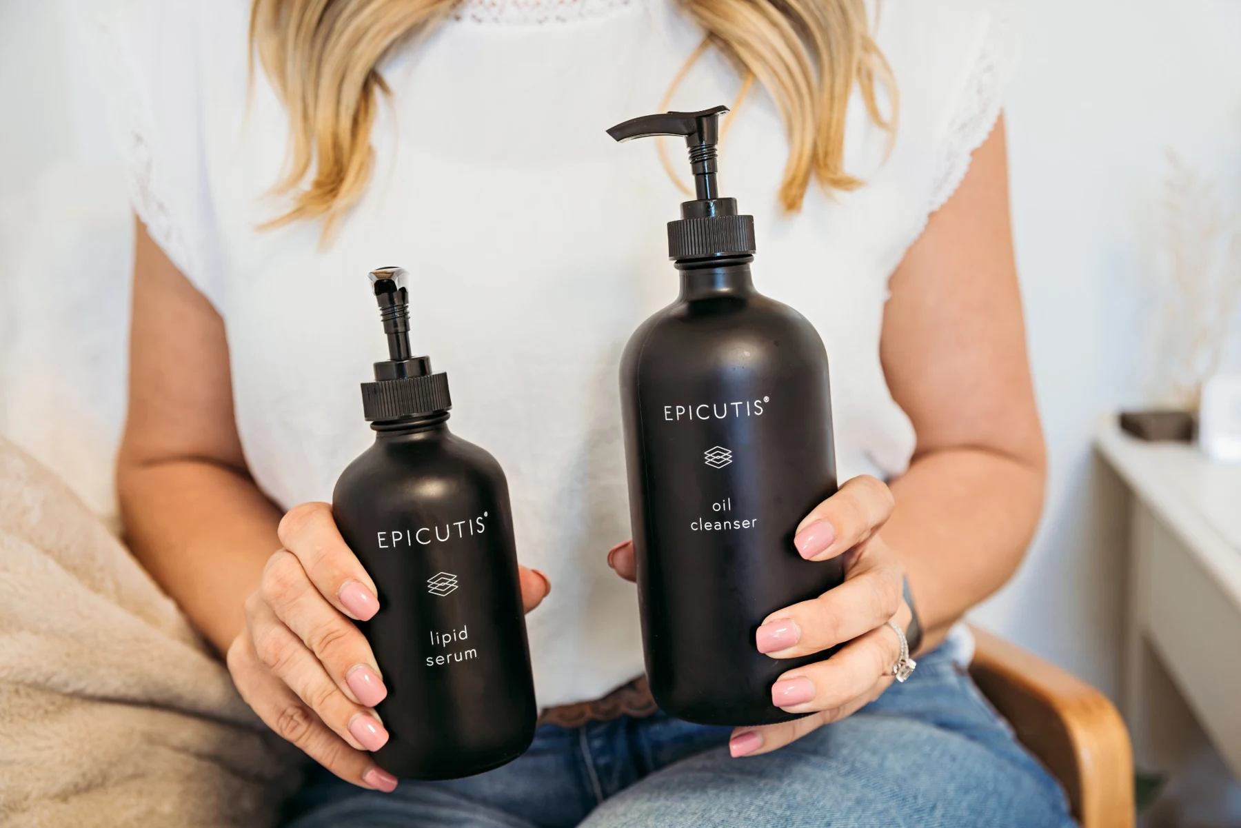 Cassie holding Epicutis lipid serum and oil cleanser at The Aesthetics Barn